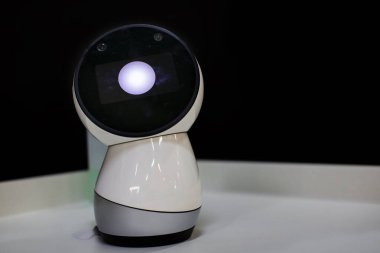 Robot device on a dark background.