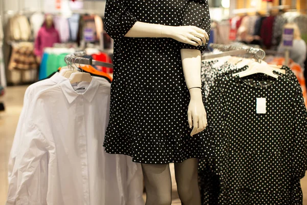 Department for the sale of women\'s clothing. Part of a manikin in a polka dot dress.