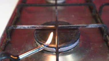 Lighter lights the gas burner of the stove
