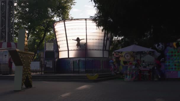 Carrousels Met Silhouetten Van Mensen Draaien Rond Een Zomerpark — Stockvideo