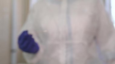 The doctor's hands hold a coronavirus test stick.