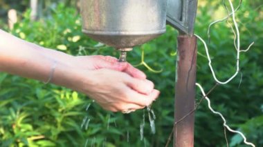 Hands are washed with water at the sink.