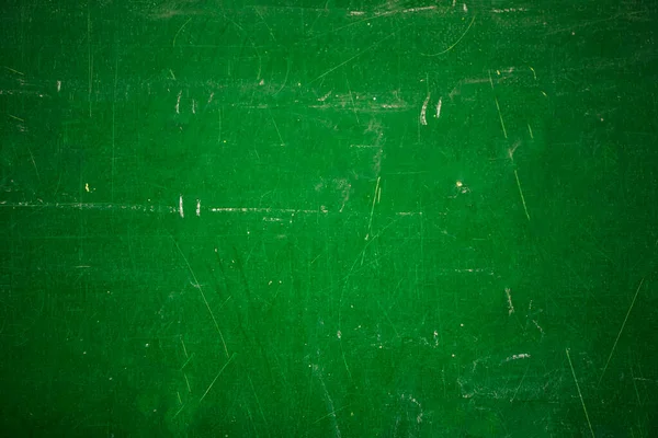 Green school board with scratches and scuffs.