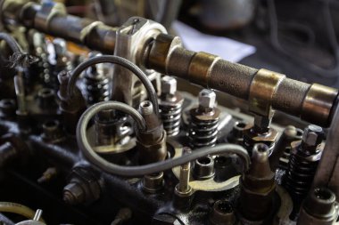 Mercedes diesel engine repair. Hands with a mechanic repairing Mercedes parts. The gas distribution mechanism of the fuel system of the car.