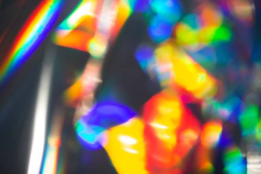 Gökkuşağı holografik bokeh arka planı. Renklerin çok renkli taşması.