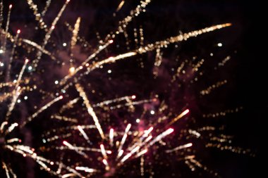 On a black background bokeh from explosions of colorful fireworks.