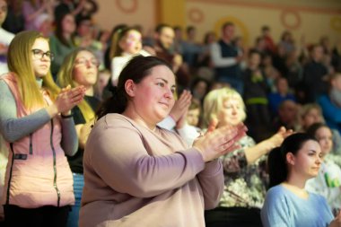 Belarus, Aftyuki village, March 28, 2021. Holiday in the city. Spectators stand and clap.