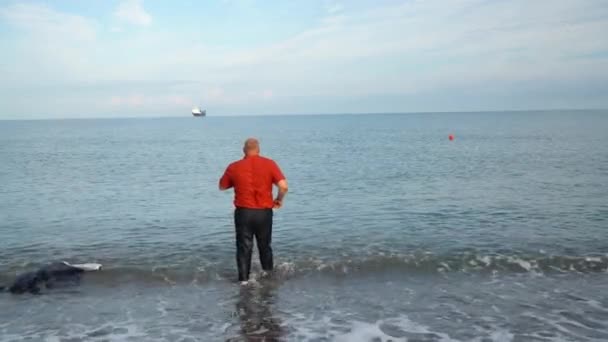 Бізнесмен Входить Море Роздягаючись Ходу — стокове відео