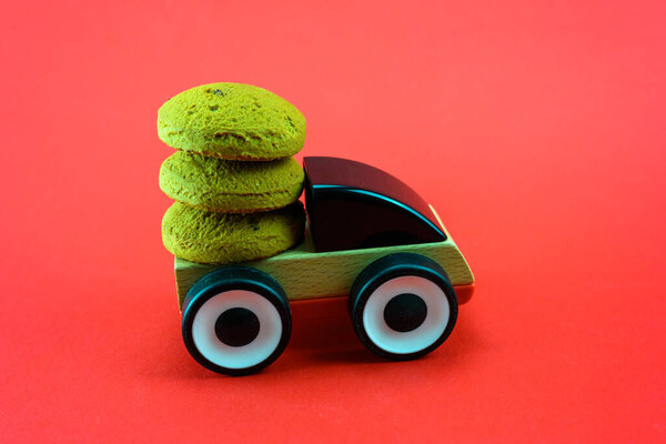 A toy car carries Christmas cookies. Christmas decoration.