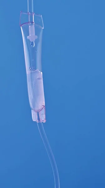 Close-up of intravenous drip in hospital, Intravenous saline solution, intravenous loading dose on the blue background.