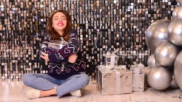 Beautiful Woman Sits Floor Opens Rejoices Gift Silvery Shiny Background — Stock Video