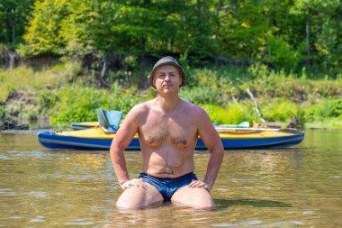 Kayığın arka planında güçlü bir adam. Hızlı nehirde rafting. Macera dolu bir hayat tarzı. Seyahat tutkusu kavramı. Aktif hafta sonu tatili vahşi doğa. Kano gezisi..