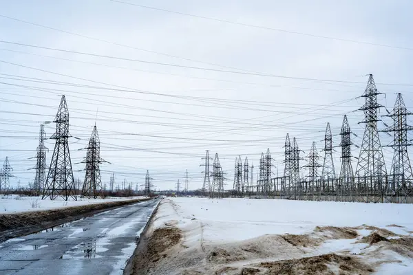 The energy, electric poles, wires, power supply, power plant. The early spring, snow. High quality photoThe energy, electric poles, wires, power supply, power plant. The early spring, snow.