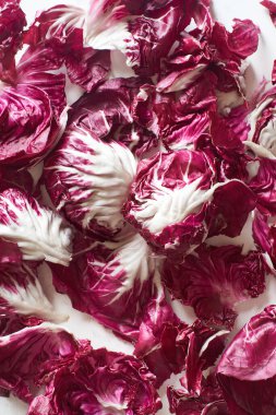Fresh radicchio salad leaves arranged on marble cooking table. View from above