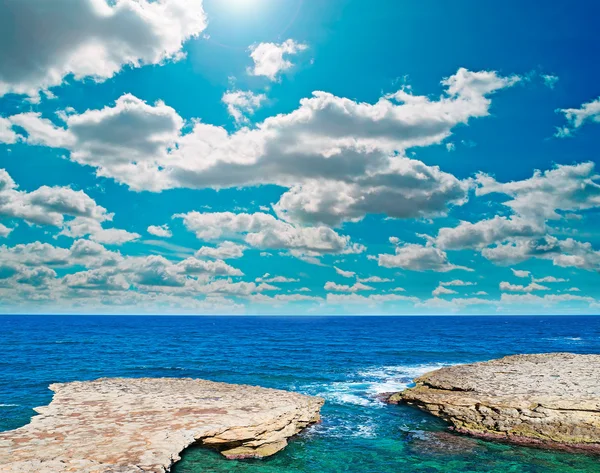 Rocky coast and clouds — Stock Photo, Image