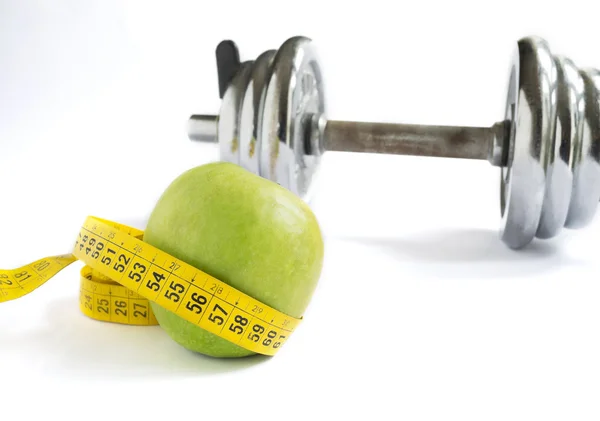 Apple, tape and dumbbell — Stock Photo, Image