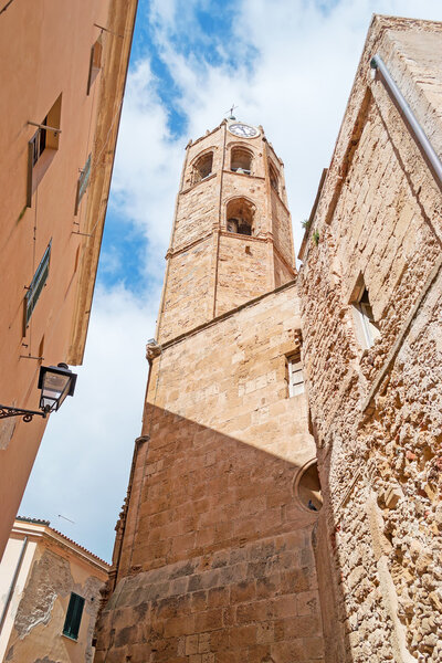 Alghero Duomo bell tower seen from below through old buildings
