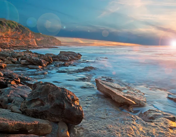 Sunset and lens flare by the shore — Stock Photo, Image