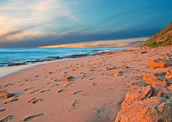 Sand and rocks at sunset — Stock Photo, Image