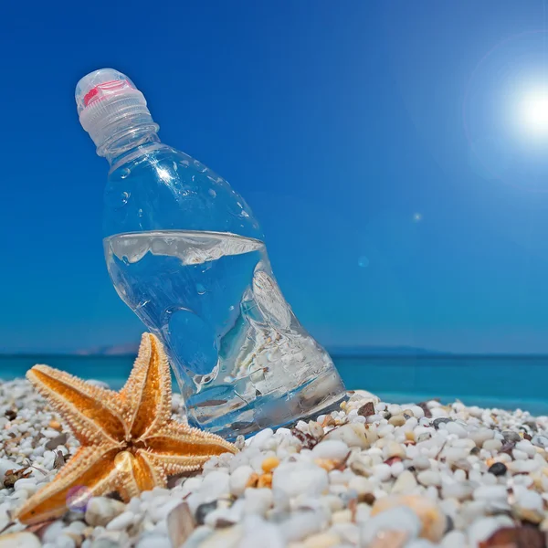 Botella, estrella de mar y sol —  Fotos de Stock