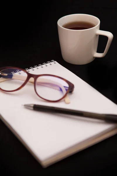 Top View Notepad Cup Tea Stylish Glasses Vertical Image — Stock Photo, Image