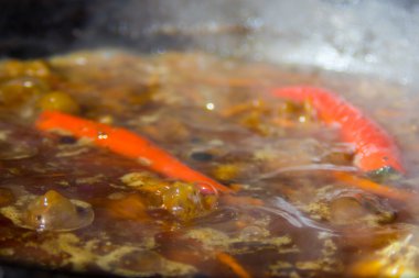 Biber ve sarımsak bir kazanda pişirilir.