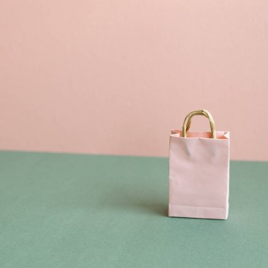 Yeşil ve pembe arka planda kağıt alışveriş torbası. kopyalama alanı ile