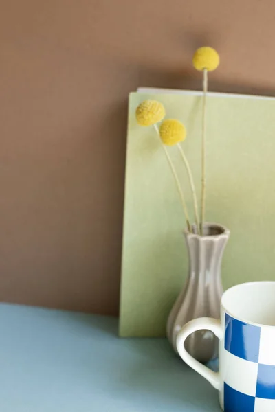 Notebook Cup Dry Flower Blue Desk Brown Wall Background — стоковое фото