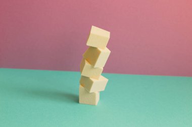 Stack of makeup sponge on mint green table. pink wall background