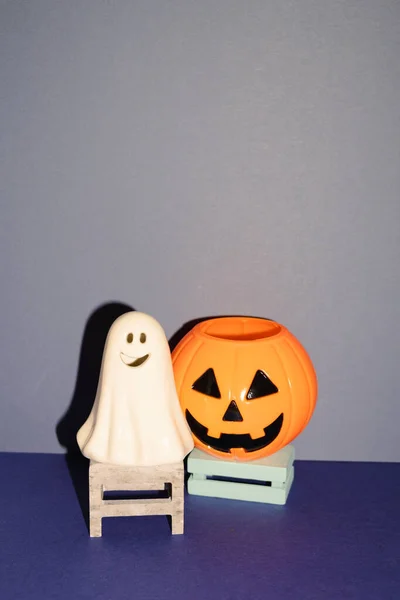 Halloween party decor, ghost and pumpkin on blue background