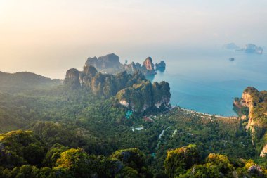 Tropikal bir sabahta kayalık dağların ve denizin yaz manzarası, yengeç.