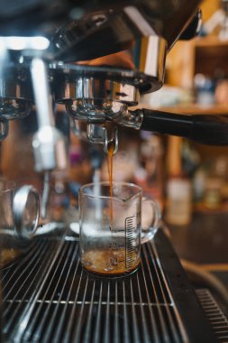 Expresso coffee dripping from the machine,black coffee