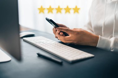 Hand and Phone With Five Star Rating at home 