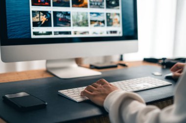 Man working on computer desk and smartphone at home office