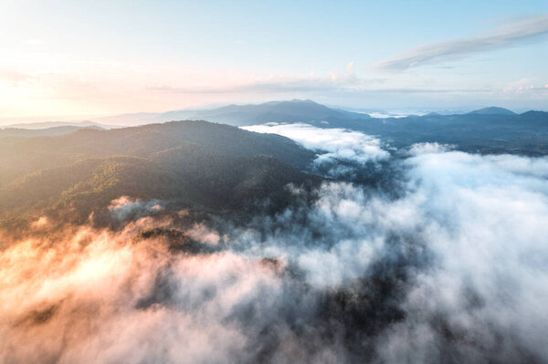 fog with mountains and light in the morning,from high angle