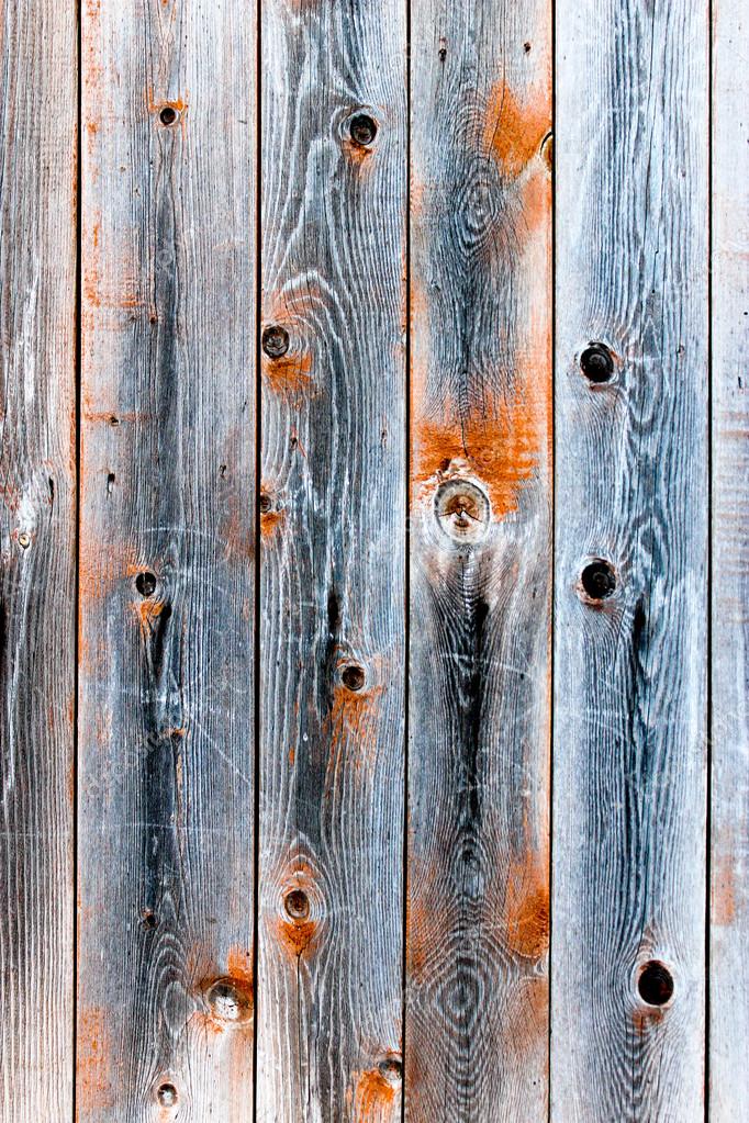 Wooden fence of smoky color with knots