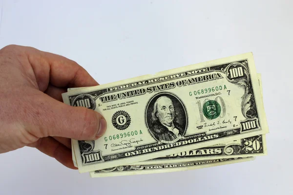 Hand holding US dollars on a white background — Stock Photo, Image