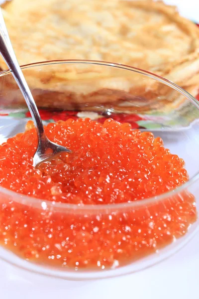Red caviar in a plate with the spoon — Stock Photo, Image