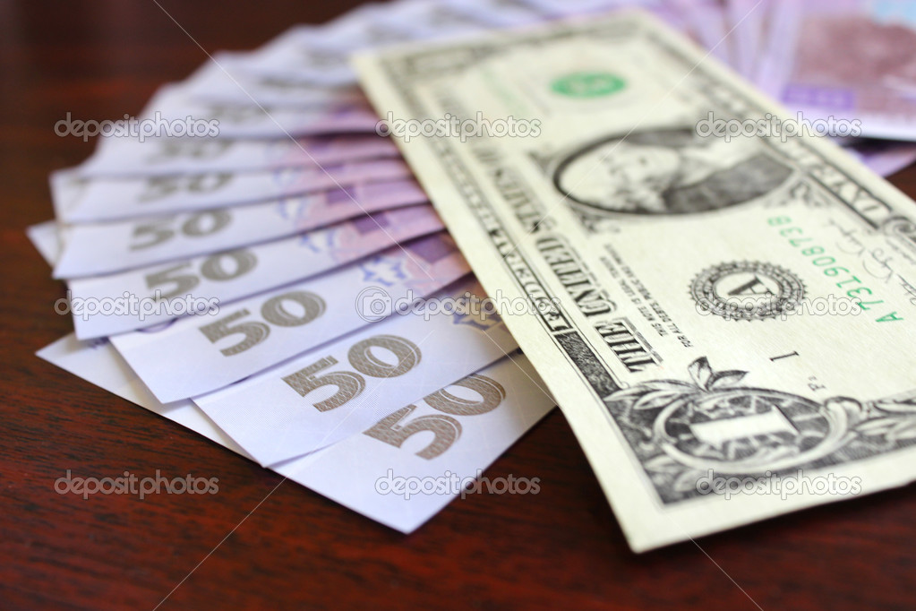 dollar and grivnas banknotes isolated on dark background
