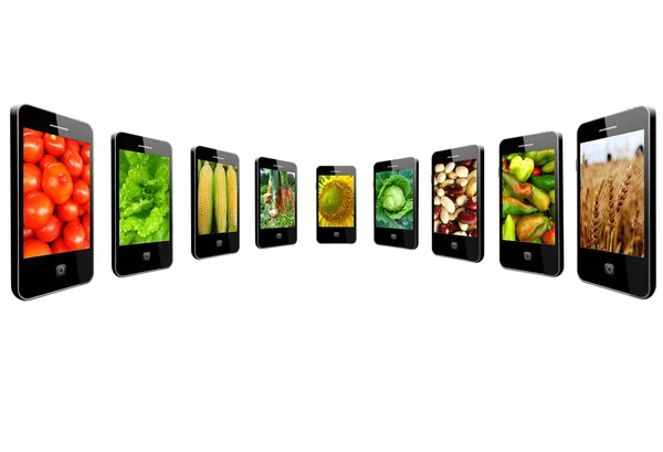 Mobilní telefony s obrázky různých druhů zeleniny — Stock fotografie