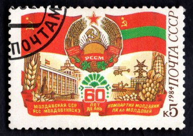 Moscow, USSR - Circa 1984: Postage stamp dedicated to communist party of Moldova. Soviet coat of arms of Moldova