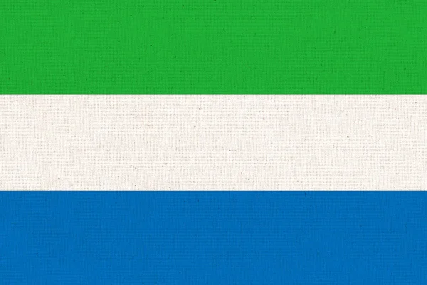 シエラレオネの国旗 シエラレオネは布の表面に旗を掲げている 生地の質感 パターン化された背景にシエラレオネの国民のシンボル シエラレオネ共和国 — ストック写真