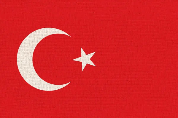 Flag of Turkey. Turkish flag on fabric surface. Fabric texture. National symbol of Turkey on patterned background. Republic of Turkey