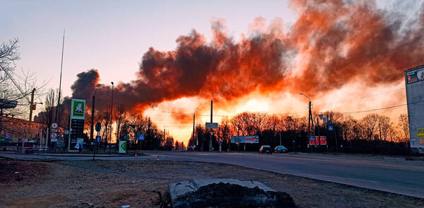 Smoke from fire on outskirts of city after air strike by Russian aircraft on city of Chernihiv. Horrors of war in Ukraine. Fire during the war. Fire in city after shelling