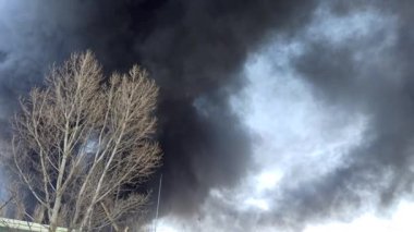 Chernihiv - Ukraine. 08 March 2022: Smoke from fire in the city after an air strike by Russian aircraft on the city. Horrors of war in Ukraine. Black smoke against sky. Fire during the war. Disaster