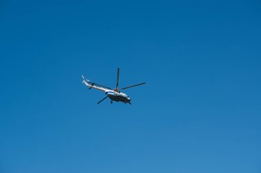 Modern helicopter flying in the blue sky.Flying transport helicopter.The aircraft, the big helicopter at competitions makes flight at low height.