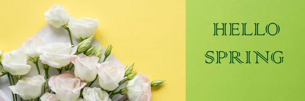 Hello Spring hand lettering inscription and eustoma flowers on bright yellow background. Lettering spring season.web banner.stylish flat lay. soft light, tenderness atmospheric moment. — Stock Photo, Image