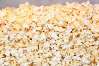 Salted popcorn grains on the white background