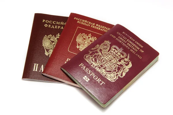 Три разных паспорта, изолированных на белом — стоковое фото