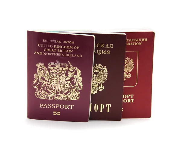 Tres pasaportes diferentes aislados en blanco — Foto de Stock